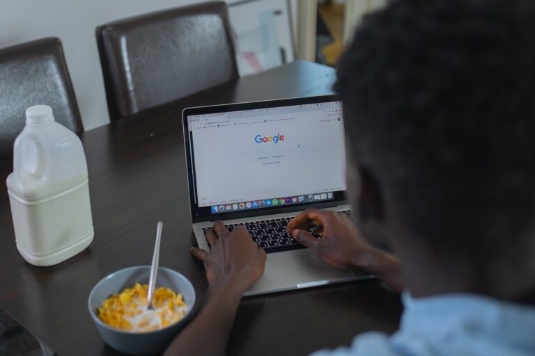 A Person Using Google Website on a Laptop